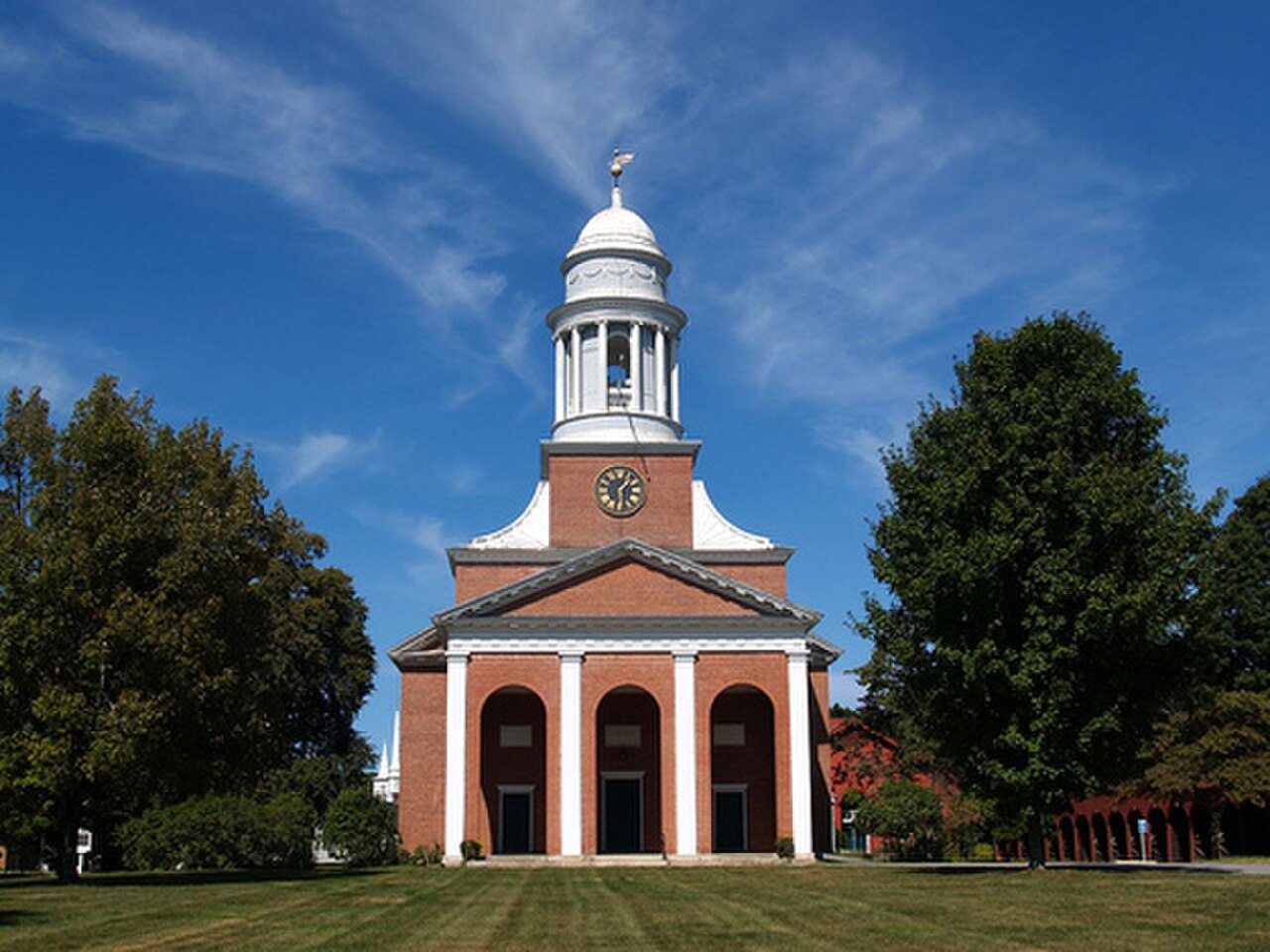 The brick First Church of Christ in Lancaster, with a white cupola and columned portico