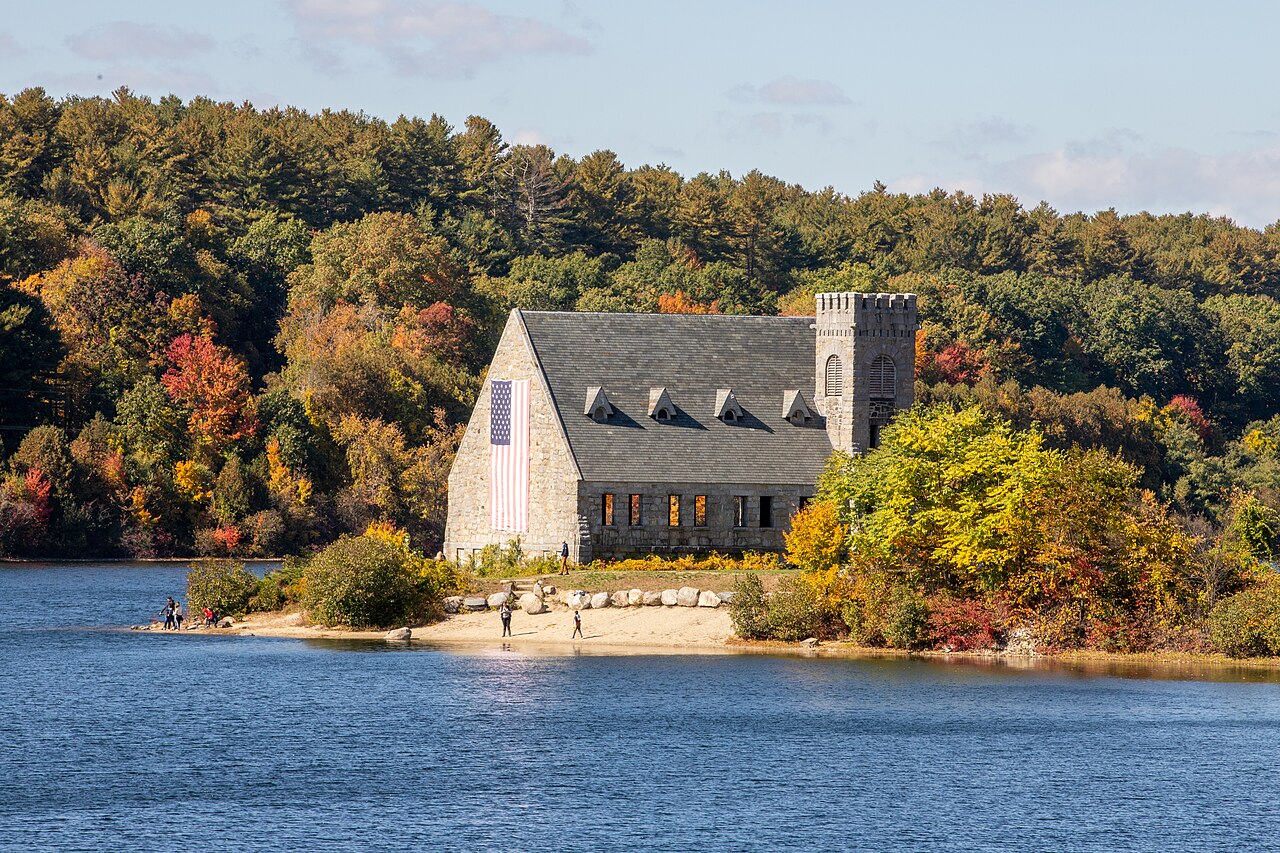 The Old Stone Church beside the Wachusett Reservoir in autumn, with orange and yellow trees